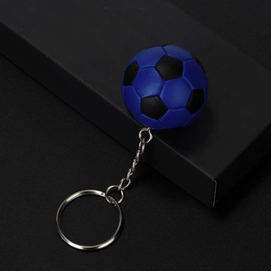 Detailed view of mini blue and black football keychain with realistic leather texture