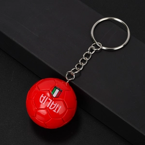 Close-up of red mini soccer keychain with Italia text and Italian flag detail