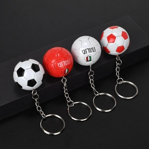 Detailed close-up of mini soccer ball keychains with Italia flag and textured stitching