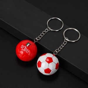 Detail of red Italia soccer keychain and red-white football with silver metallic ring
