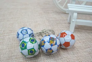 Detailed set of soccer keychains featuring team logos on textured fabric background