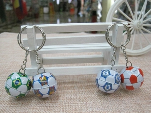 Mini football keychains featuring Brazil, Barcelona, and Chelsea designs on a white stand