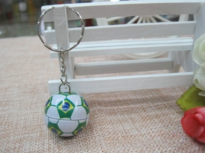 Detailed view of mini Brazil flag soccer keychain hanging on a white decorative bench