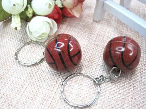 Detail view of two basketball keychains with black seam lines and silver rings