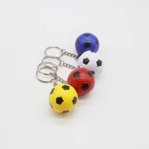Detailed view of four colorful mini soccer ball keychains in red, blue, yellow, and white