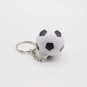 Detailed close-up of a mini soccer ball keychain with classic black and white pentagon patterns