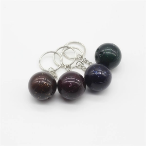 Close-up of set of four colorful bowling ball keychains with metallic glitter finish