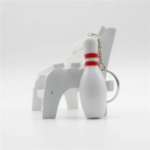 Macro view of mini bowling pin keychain with red stripes and silver metal chain link