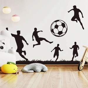 Detail of soccer player silhouettes and grass wall stickers in a child room setting