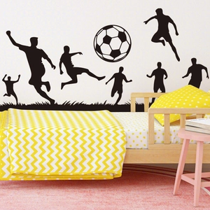 Detail of soccer player silhouettes and ball wall decals in a child's bedroom setting