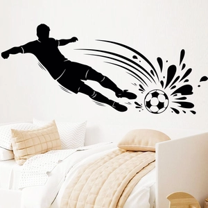Close-up of black silhouette soccer player wall decal in a cozy bedroom setting