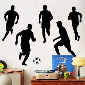 Detail showing five black soccer player silhouettes and a ball on a white wall