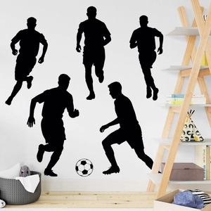 Detail of soccer silhouettes and ball stickers on a white wall for home decor