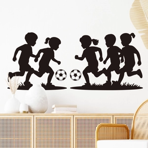 Detail of black soccer kids wall stickers on white wall with wood furniture decor