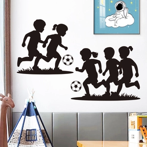Kids football silhouette wall decals showing children playing soccer in a cozy bedroom