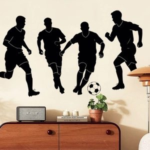 Detailed view of black vinyl soccer player silhouette wall decals in a modern living room