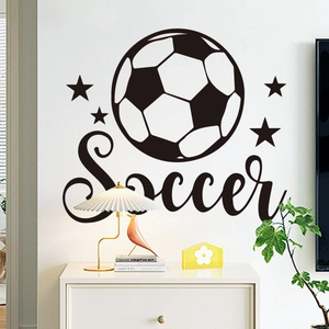 Macro detail of a soccer wall sticker with stars and artistic typography on a white wall