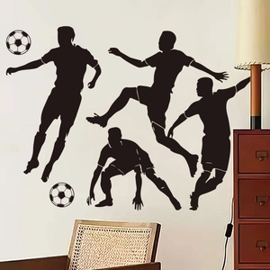 Detail of four black soccer player silhouette stickers on a minimalist white living room wall