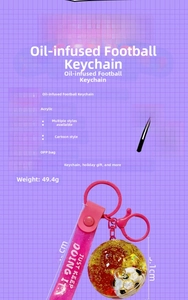 Detailed view of acrylic liquid quicksand soccer keychain with pink glitter strap and metal hook