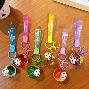 Creative soccer liquid quicksand keychain set in six vibrant colors on wood background
