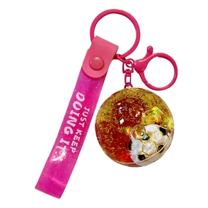 Pink soccer keychain with liquid quicksand football pendant and silicone strap