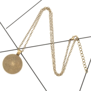 Macro detail of antique bronze pendant back with mesh texture and adjustable clasp chain