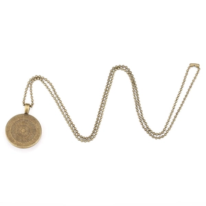 Close-up of vintage bronze ball chain necklace with a circular DIY photo pendant tray