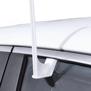 Close-up of a white plastic car window flag pole bracket mounted on a vehicle window