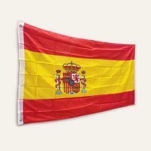 Detailed view of the Spanish flag with national coat of arms and reinforced metal grommets