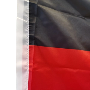 Close-up of double-stitched reinforced white border on a black and red German flag