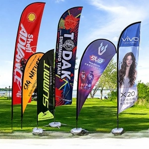 Custom football club pennants and feather banners displayed on outdoor green lawn