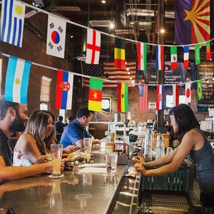 String of flags from multiple countries hanging over a bar counter for world soccer events