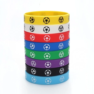 Close-up of multi-colored silicone sports wristbands featuring printed football patterns