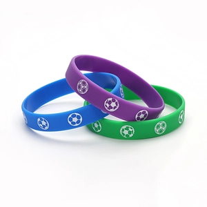 Three-piece silicone football wristband set in blue, purple, and green colors
