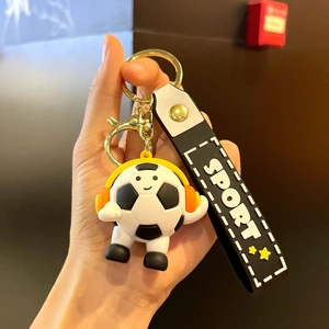 Cartoon soccer keychain with headphones, black white strap and sport theme design