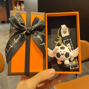 Creative soccer doll keychain with wings in an elegant orange gift box packaging
