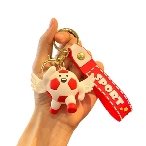 Cartoon football keychain with red wings and sport wrist strap shown in hand