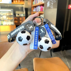 Detail of soccer keychain with goal wristband and blue acrylic football stadium signage