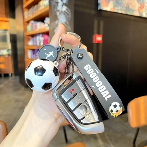 Close-up of football keychain featuring Goal printed silicone strap and a 3D soccer pendant