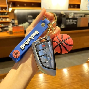 Detail of basketball keychain with blue silicone strap and 3D ball held in hand