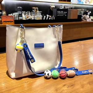 Off-white tote bag with blue trim featuring creative sports ball keychain pendants set