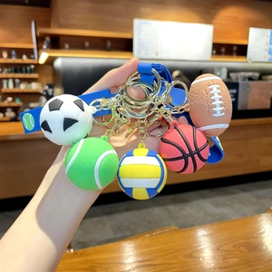 Close-up of assorted sports ball keychains with blue silicone straps and metal hooks