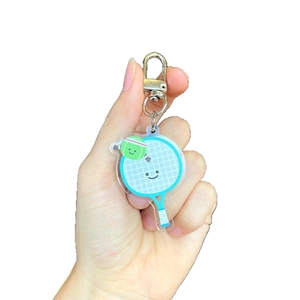Porte-clés mignon raquette de tennis bleue en acrylique avec balle smiley et mousqueton