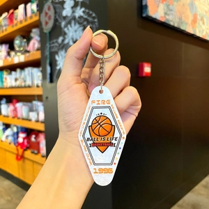 Macro view of a diamond-shaped basketball keychain with Fire and Ball Is Life text