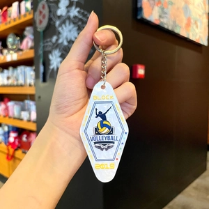 Detail of volleyball acrylic diamond keychain with athlete silhouettes and metal ring