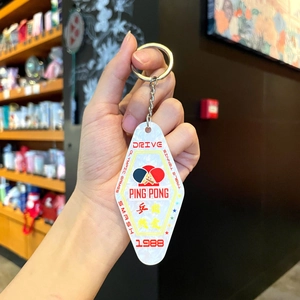 Macro view of retro diamond-shaped acrylic table tennis keychain with sporty ping pong graphics