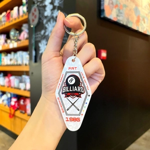 Macro detail of diamond-shaped acrylic billiard keychain with 8-ball and snooker print