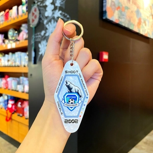 Detail of soccer acrylic keychain with polar bear design and metallic key ring