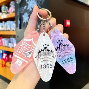 Set of three diamond-shaped acrylic keychains in pink white and purple marble finish
