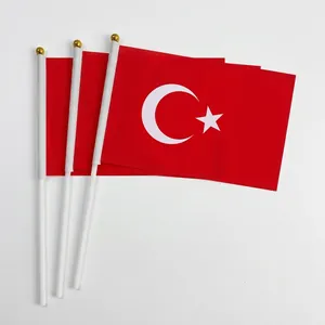 Three handheld Turkey national flags with white star and crescent on red polyester fabric